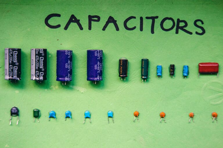 Various capacitors arranged on a green surface showcasing electrical components.